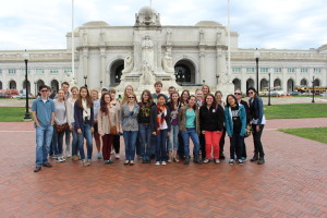 group of students posed in front of Union Station.