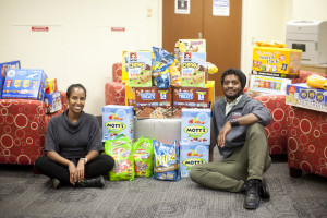 Birhane and Middleton with the stack of snacks they purchased for hungry, stressed-out students during exam week's Stress-Free Zone. Photo by Karen Pearlman.