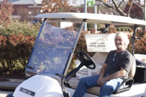Greg Render, who retired from Fairfax County Public Schools, delivers UMW mail across campus. Photo by Karen Pearlman.