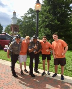 UMW Police Chief Mike Hall, left, and Office M. Jackson, with students on Move-In Day. The agency became only the fifth campus department to receive accreditation.