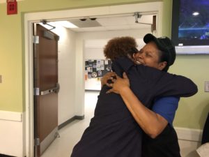 Dora Whiting takes a minute at her job at the Eagle's Nest to hug Yasmin Cox, who will receive her master's of education degree next week. Whiting has worked at UMW's Eagle's Nest for more than two decades.