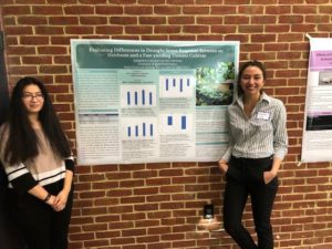Carmen Martinez, left, and Josephine Gray display poster on biology research.