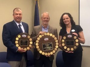 From left to right, Interim Athletic Director Patrick Catullo, UMW President Troy Paino and Vice President for Student Affairs Juliette Landphair accept Mary Washington’s Capital Athletic Conference awards this morning. Eagles teams swept the top three spots for the 2018-19 season. Photo by Clint Often.