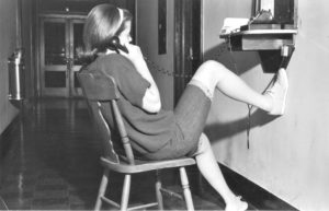 A Mary Washington student using a hall telephone in 1965.