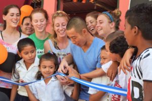 2007 alumnus Shin Fujiyama inaugurates a school built by his nonprofit, Students Helping Honduras, which he started at UMW. SHH has built 55 schools in the impoverished country, which is currently on lockdown. While much of his staff have been evacuated, Fujiyama stayed behind in Honduras to care for 24 orphaned children. Photo courtesy of SHH. 