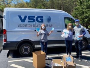 Robin Jones (left), contracts manager for UMW Facilities Services, with freshman Alexandra Perrault (center) and her father, Rick Perrault, CEO of Visiontech Solutions Group in Troy, Virginia. Visiontech donated $1,500 worth of PPE to Facilities Services. 