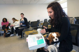 UMW senior Claudia Woods, president of the student club DiversAbility (shown here in a psychology course last year with her service dog, Hearo), is taking “Intro to Disability Studies.” Offered for the first time this fall, the course takes an interdisciplinary look at disability as key to the human experience as race or gender. Photo by Suzanne Carr Rossi.