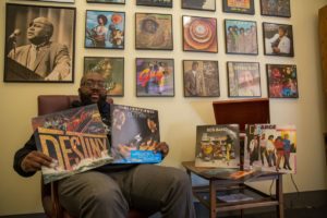 JFMC Assistant Director Chris Williams with some of his favorite record albums. A prolific music writer, Williams will teach a music history course at UMW this fall. Photo Credit: Sabrina Vaz-Holder/The Free Lance-Star.