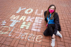 UMW sophomore Grayson Collins, who spent UMW’s 2021 MLK Day of Service chalking Campus Walk with positive messages. Photo by Suzanne Carr Rossi.