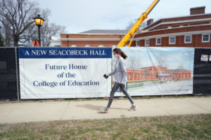 A student passes by Seacobeck Hall, which is under construction as the new home of UMW’s College of Education and slated for completion early next year. Photo by Suzanne Carr Rossi.