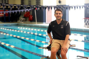 UMW Swim Coach Justin Anderson '10 perched in front of Goolrick Pool. Photo by Karen Pearlman Photography. 