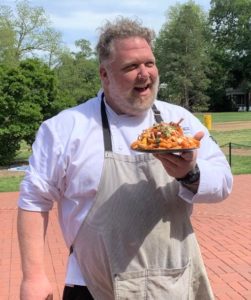 UMW Executive Chef Peter Stine with a plate of "Chicken Feed Fries."