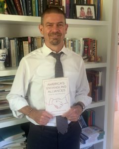 Professor of Political Science and International Affairs Jason Davidson with his book, "America's Entangling Alliances: 1787 to the Present."