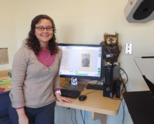 Angie Kemp poses with the Simpson Owl in the Digital Archiving Lab.