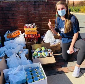 Junior Caitlin O'Leary helps at last year's food drive.