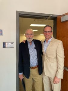 Professor Emeritus of Business Galen deGraff stands with Rob Strassheim ’96 in the doorway of the newly named Galen deGraff Classroom in Woodward Hall. Photo courtesy of Rob and Sarah Strassheim.