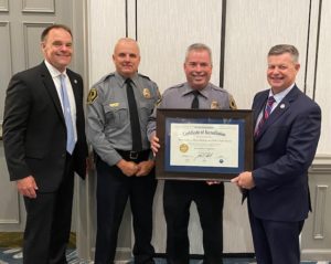 UMW Police Lt. Bill Gill and Chief Michael Hall receive the certificate of accreditation at a recent ceremony. At left is Jackson Miller, director of the Virginia Department of Criminal Justice Services, and at right is Robert Mosier, Virginia secretary of Public Safety and Homeland Security.