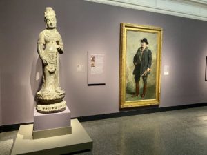 The 1908 portrait of Theodore Roosevelt Gari Melchers appears next to a statue of a Tang Dynasty bodhisattva.