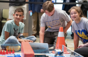 Members of the King George High School robotics team eye the clock as their time runs out during the Innovation Challenge @ Dahlgren. The Foxes fielded three separate teams during the event that took place in April 2022 at the University of Mary Washington Dahlgren Campus. (U.S. Navy photo/Released)