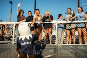 Sammy D. Eagle mingles with fans at a UMW women’s field hockey game. Happening this week, UMW Homecoming features an array of events and athletic competitions.