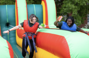 Giant inflatables, like this two-lane bungee race, were part of the fun at this year&rsquo;s Devil-Goat Day at the University of Mary Washington. The annual late-April competition pits Devils, who graduate in odd years, against Goats, who graduate in even years, on a quest to collect the most points for participation and wins. Photo by Parker Michels-Boyce.