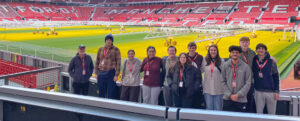 A UMW study-abroad group poses at Old Trafford Stadium, home of the Manchester United Football Club in England. The spring break trip is one of many that students can learn about at UMW’s Global Cafe and Education Abroad Fair events this fall.