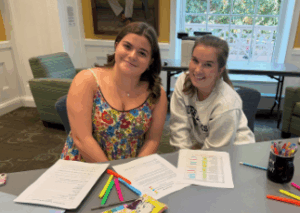 UMW first-year student Lucy Rabung (left) sought the help of her peer mentor, Lauren Spagnuolo, a sophomore, who helped her organize all her syllabi and record the dates of her assignments in a new day planner, provided by LaunchPad.