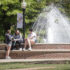 Photo of UMW campus fountain with students sitting next to it.