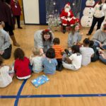 Students hand out gift boxes to area preschool students.