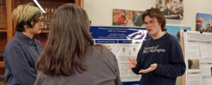 Students stand in front of poster presenting original research at the Jepson Science Fall Symposium at University of Mary Washington.