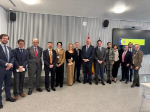 Adult men and women standing posed in a conference room