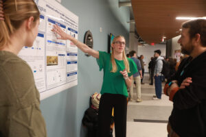 Photo of Carleigh Wood (left) and Delaney Humphrey, both biology majors on a pre-med track, present their research on myotonic dystrophy using fruit flies during the Jepson Science Center Fall Research Symposium in 2024. Photo by Karen Pearlman.