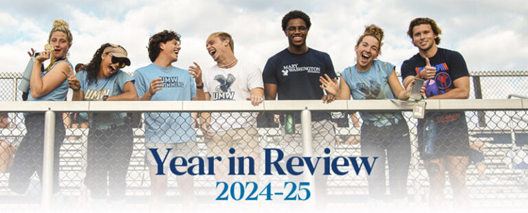 Cover of the Year in Review publication with students standing at the railing of stadium stands