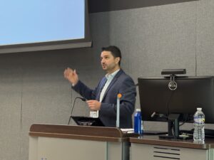 adult male giving presentation in classroom