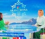 two woman sitting at a desk for a discussion