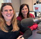two adult women seated in front of microphones