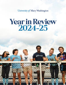 Picture on the cover of the Year in Review publication wtih students standing at the railing of the stands at the soccer fields