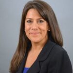 Photo of a woman in a black blazer who is Michelle Rose