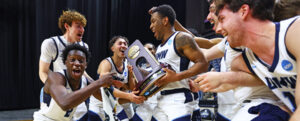 Photo of UMW basketball players holding a trophy