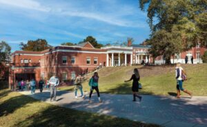 Photo of students walking by a building named Woodard Hall