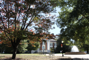 Photo with trees, fountain and building on campus