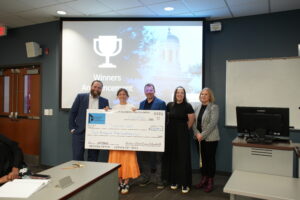 photo of student and professor with oversized check 