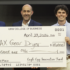 the winning student holds an oversized check accompanied by the judges