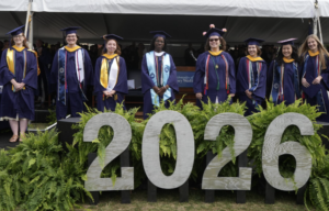 eight student award winners standing on the Commencement stage