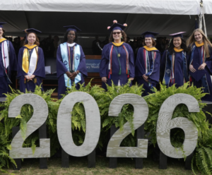 eight student award winners standing on the Commencement stage