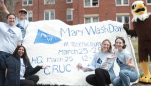 UMW mascot Sammy D. Eagle and student volunteers pictured around Spirit Rock