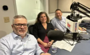 Marcel Rotter, Brooke Di Lauro, and Keith Mellinger sit together at a table to record the episode at WFVA
