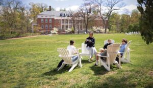 Enhanced Summer Visit Photo of students sitting in chairs on Ball Circle
