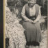 Grayscale photographic print of Gertrude Stein (right) sitting in a garden next to Alice B. Toklas (left)