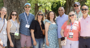 A group of alumni stand together on Campus Walk
